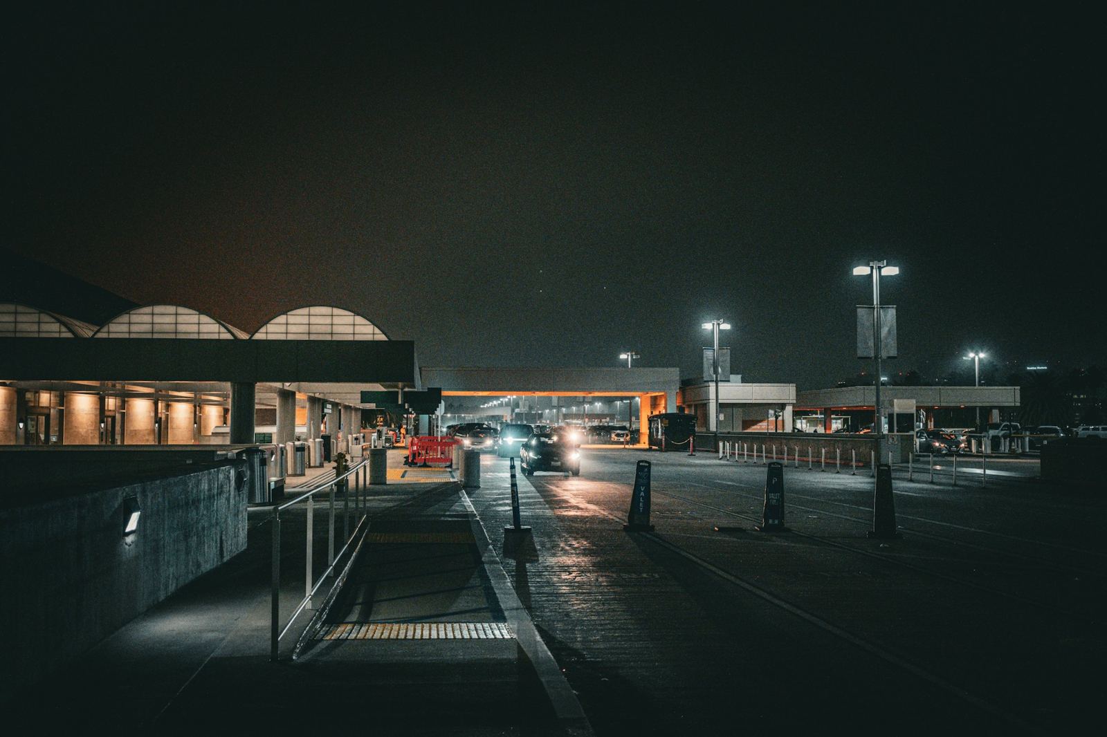 An airport terminal drop-off at night