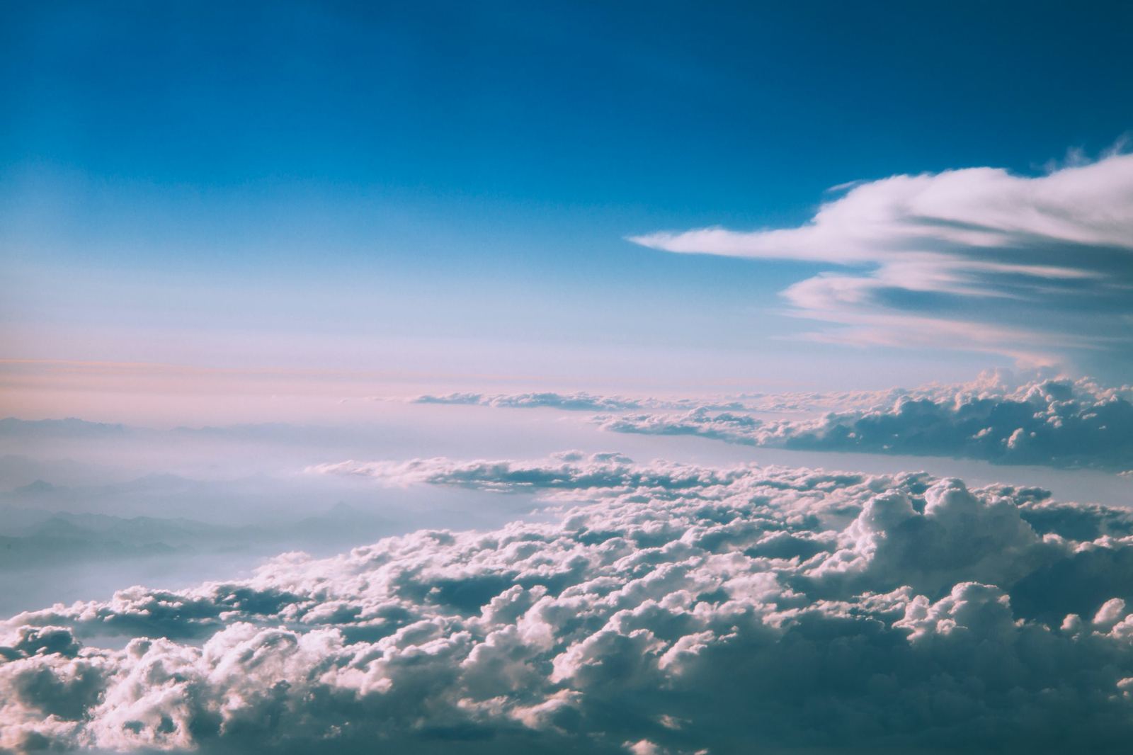 Above the clouds in a clear blue sky