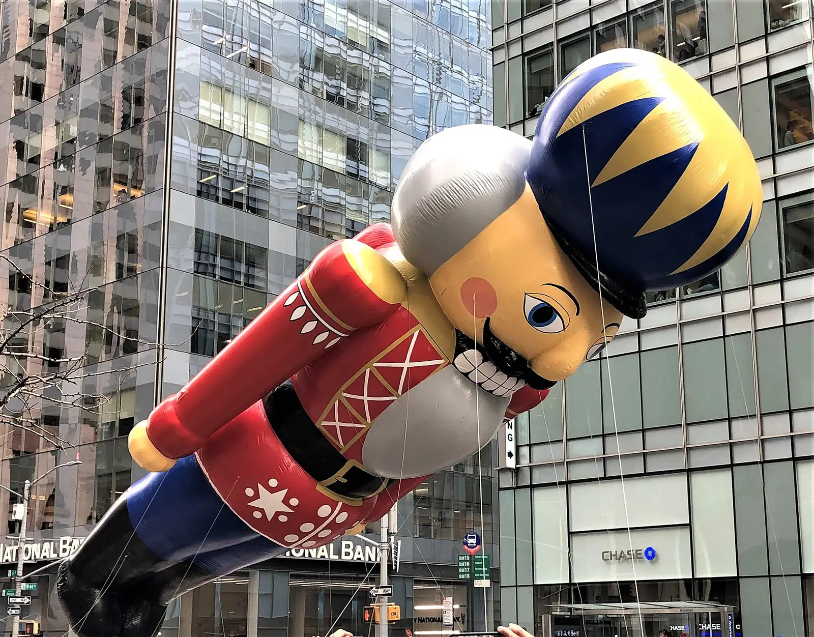 The Nutcracker balloon between Manhattan towers at the Macy's Thanksgiving Day Parade